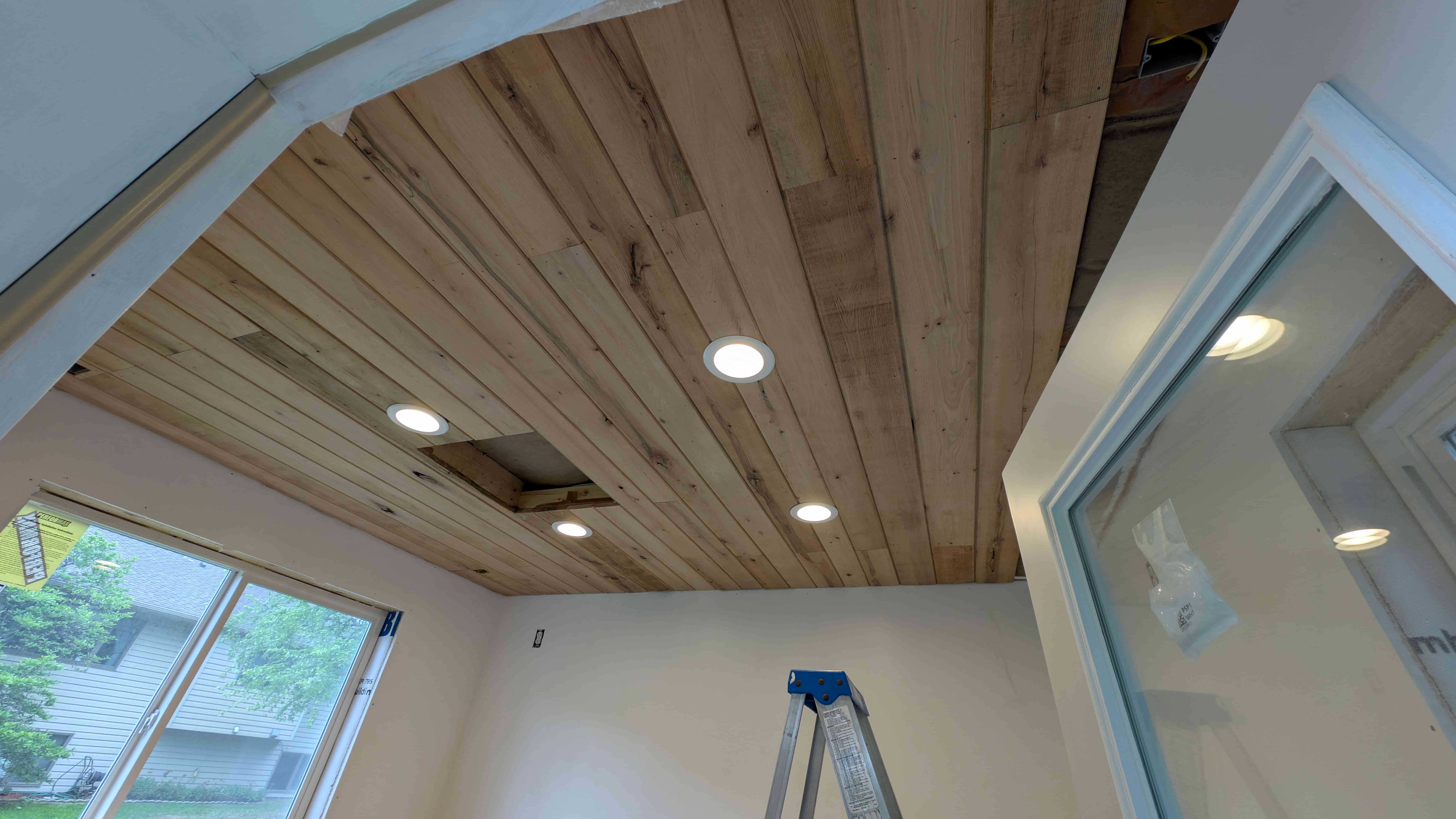 Reclaimed barn wood ceiling with recessed lights