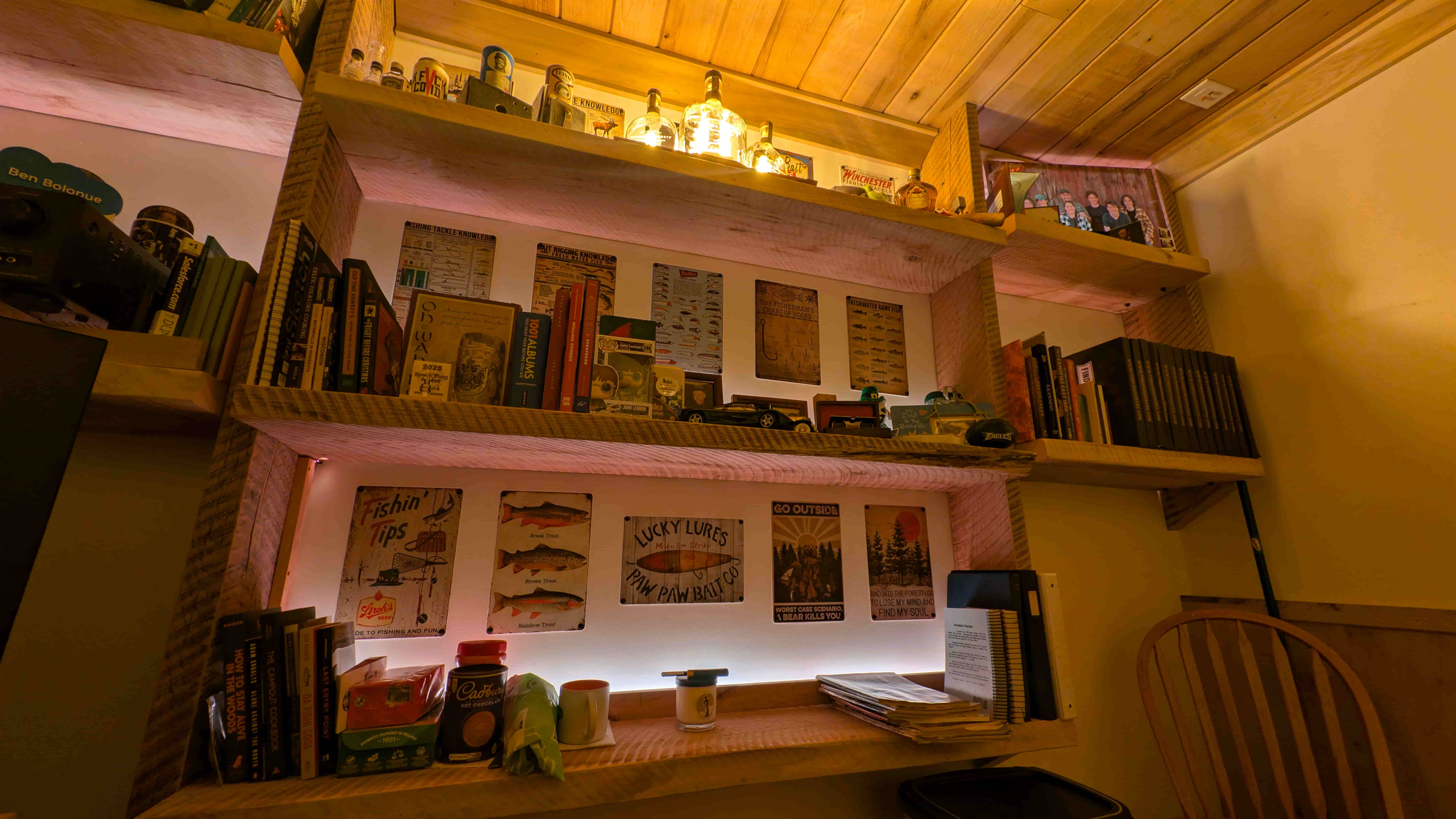 Finished office — timber shelves and bourbon bottle lamps