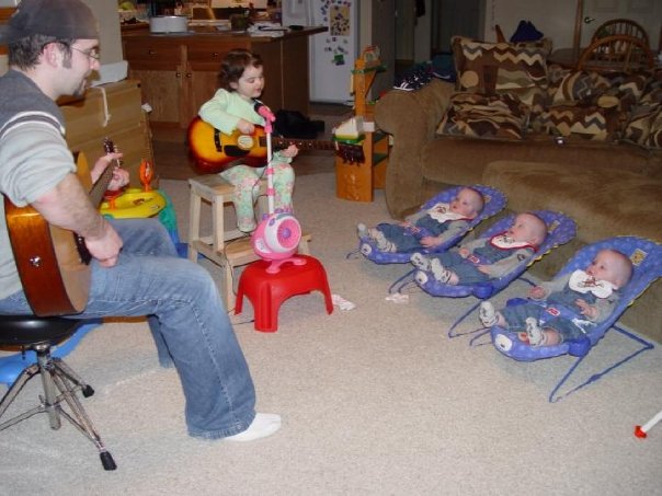 Dad and daughter give the newborn triplets their first concert